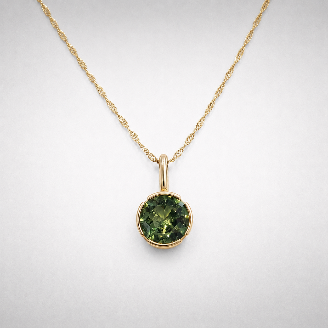 Peridot set in a 14K Gold Open Bezel